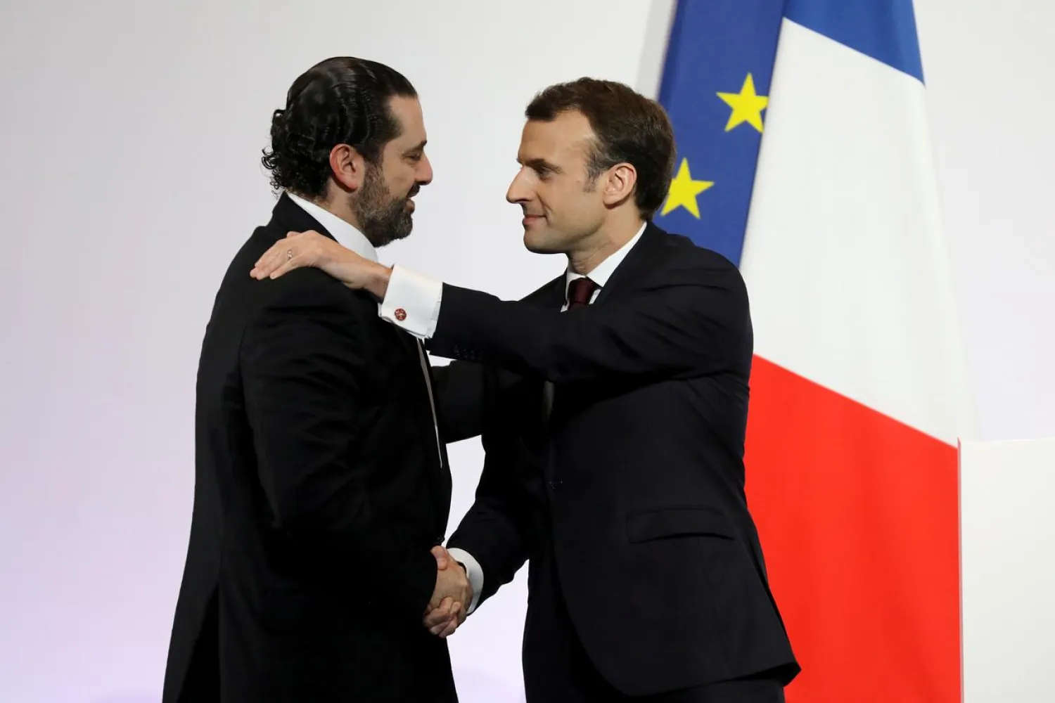 French President Emmanuel Macron (R) shakes hands with Lebanese Prime Minister Saad Hariri during the Cedar (CEDRE) Conference for international donors and investors to support Lebanon's economy, in Paris, France, April 6, 2018. Ludovic Marin/Pool via Reuters/File Photo