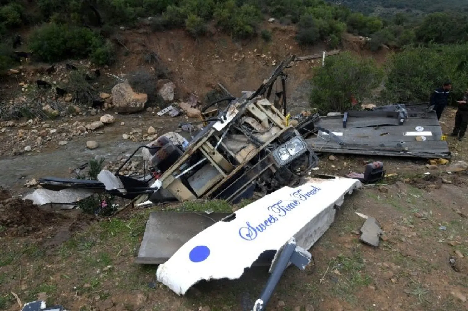 Tunisian security forces check the debris of a bus that plunged over a cliff into a ravine in northern Tunisia | AFP