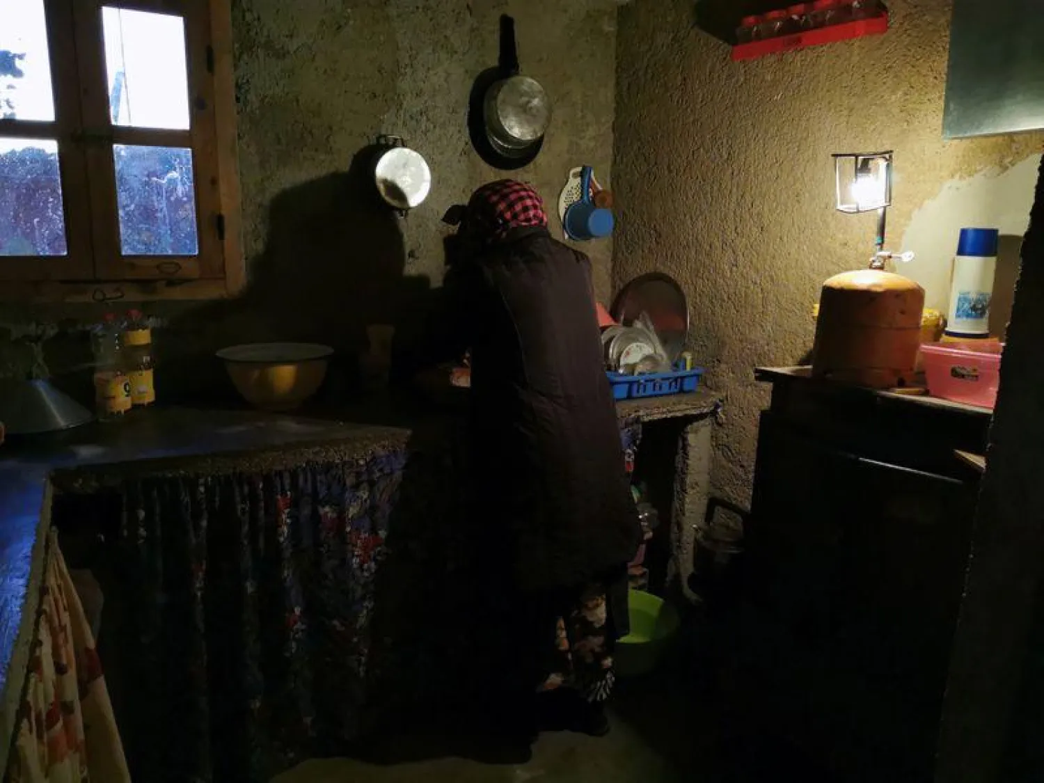  Mohammed Akki's wife works in the kitchen of their home that has no electricity and is lit by a gas lamp in the community of Ait Hammou Ouhmad on the edge of Azrou in Morocco, November 6, 2019. REUTERS/Abdelhak Balhaki