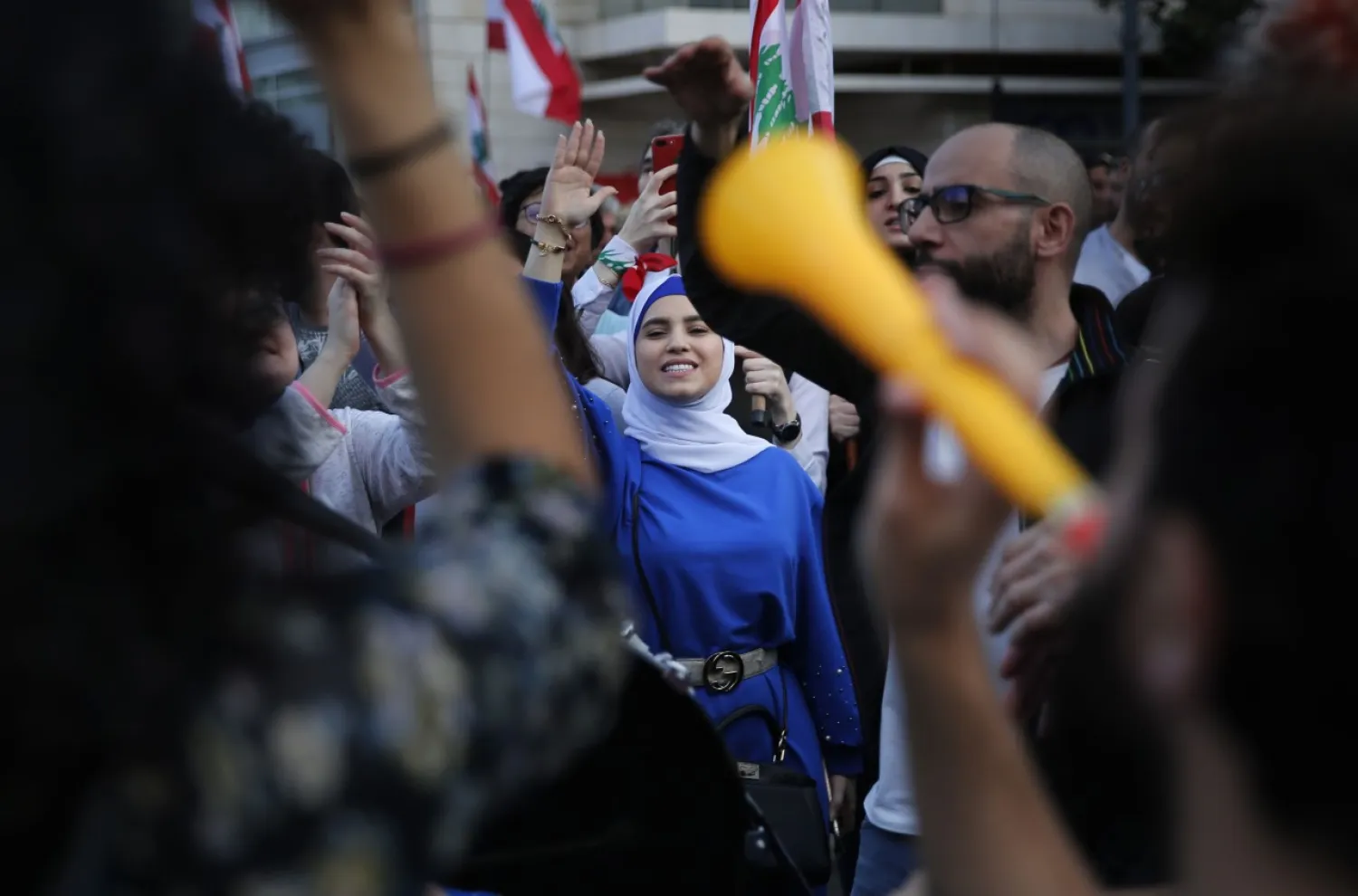 Lebanese protesters shout slogans as they march in Beirut, Lebanon, Sunday, Dec. 1, 2019. (AP Photo/Hussein Malla)