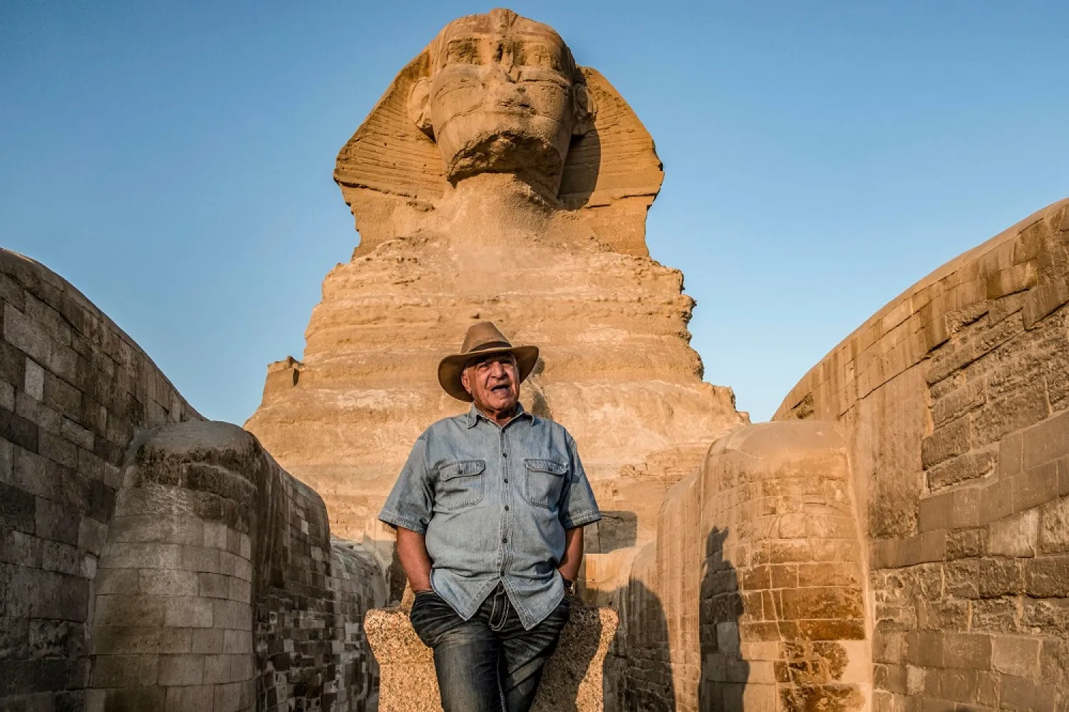 Egyptian archaeologist and former antiquities minister Zahi Hawass stands in front the Great Sphinx of Giza during a lecture with a group of tourists. (AFP)