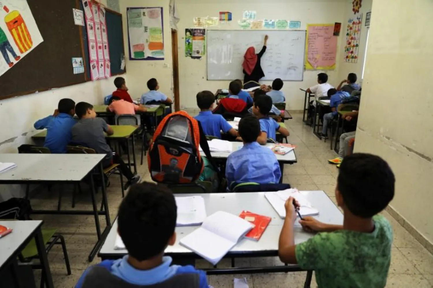 Palestinian children attend a class in a school in the East Jerusalem neighborhood of Jabel Mukhaber June 15, 2017. (Reuters)