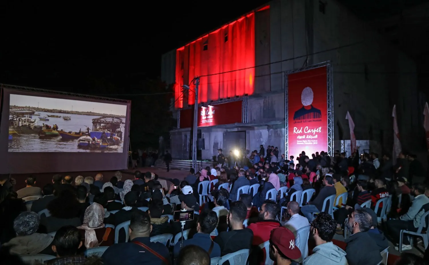 Palestinian film lovers watch a rare screening in the Gaza Strip, held outdoors after the owner of one of the territory's disused cinemas withdrew permission for it be used as a venue. (AFP)