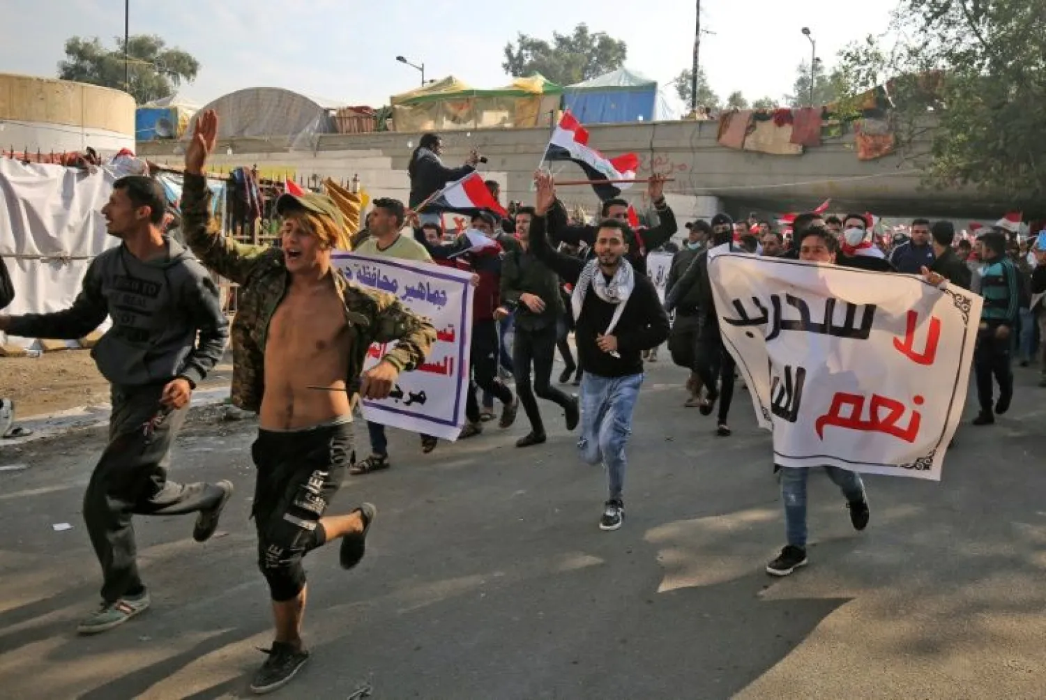Iraqi supporters of the Iran-trained Hashed al-Shaabi paramilitary force join protesters in Baghdad's Tahrir Square in what is widely seen as an act of intimidation | AFP