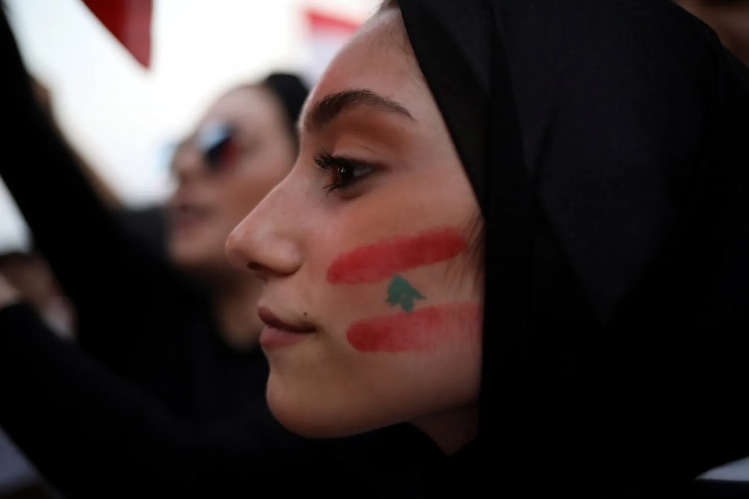 A demonstrator with a Lebanese national flag drawn on her face takes part in an anti-government protest in downtown Beirut, Lebanon, on Oct. 22, 2019. (Reuters)