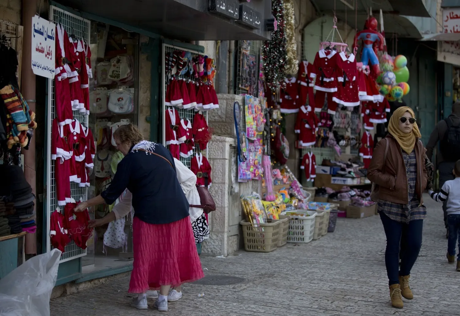In this Thursday, Dec. 5, 2019, photo, Christian visitors shop near the Church of the Nativity in the West Bank city of Bethlehem. (AP)