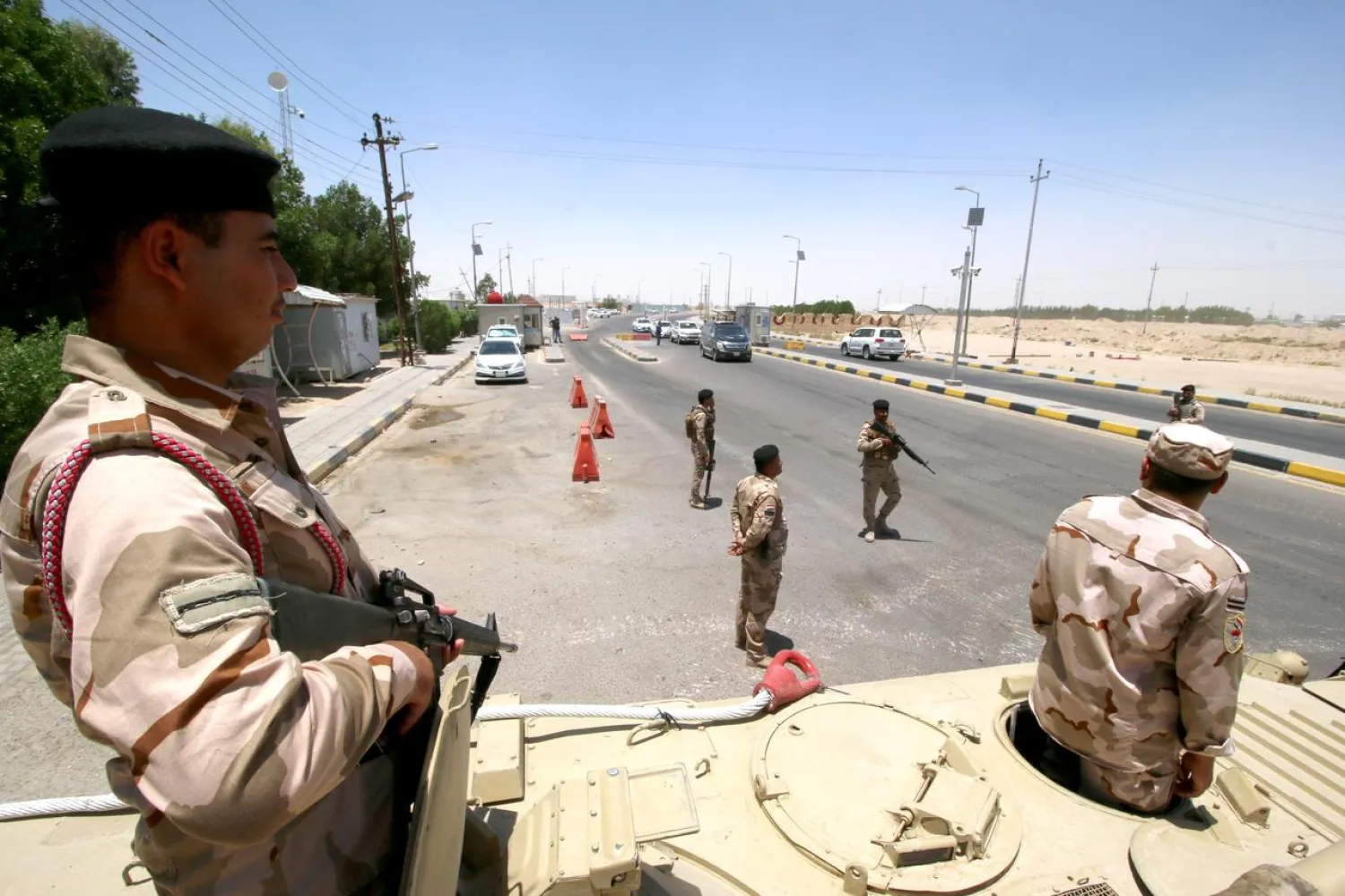 Iraqi soldiers guard the entry of Zubair oilfield after a rocket struck the site of residential and operations headquarters of several oil companies, at Burjesia area in Basra, Iraq June 19, 2019. (Reuters)
