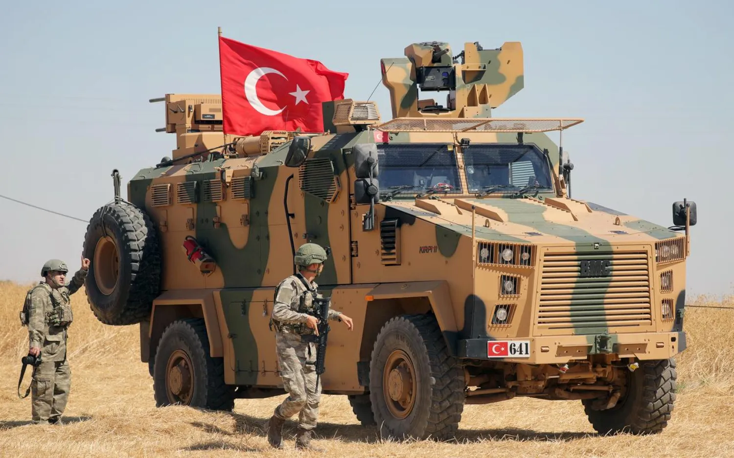 A Turkish soldier walks next to a Turkish military vehicle during a joint US-Turkey patrol, near Tel Abyad, Syria September 8, 2019. REUTERS/Rodi Said