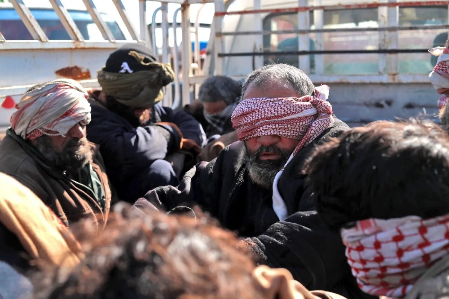 Alleged ISIS fighters who fled from the Syrian village of Baghouz, sit blindfolded in the back of a pickup truck after capture by the SDF, in the Deir Ezzour countryside on Jan. 30, 2019. (Getty Images)