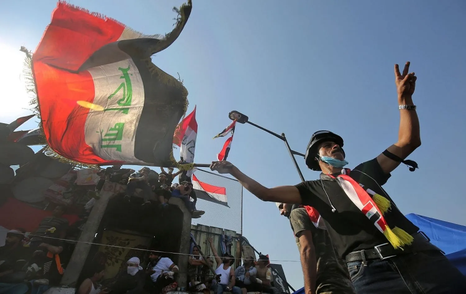 An Iraqi anti-government protester flashes the victory sign during a rally in Baghdad on November 4, 2019. (AP)