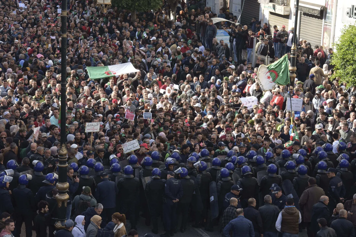 Algerian demonstrators take to the streets in the capital Algiers to protest against the government and reject the upcoming presidential elections, in Algeria, Wednesday, Dec. 11, 2019. (AP Photo/Toufik Doudou)