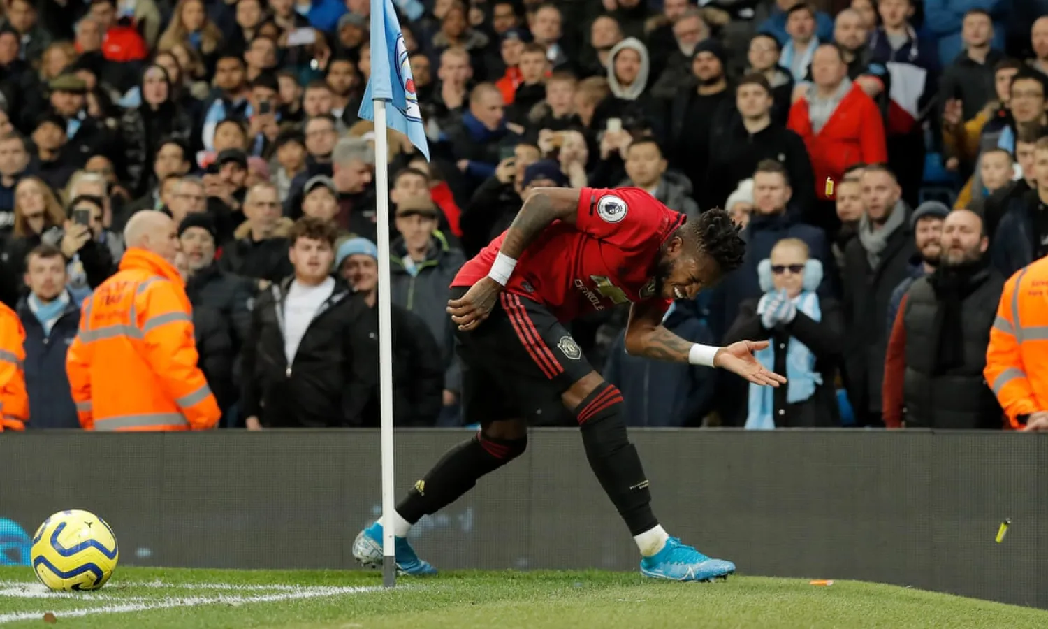 Manchester United’s Fred is hit by missiles as he tries to take a corner during the Manchester derby. Photograph: Tom Jenkins/The Guardian