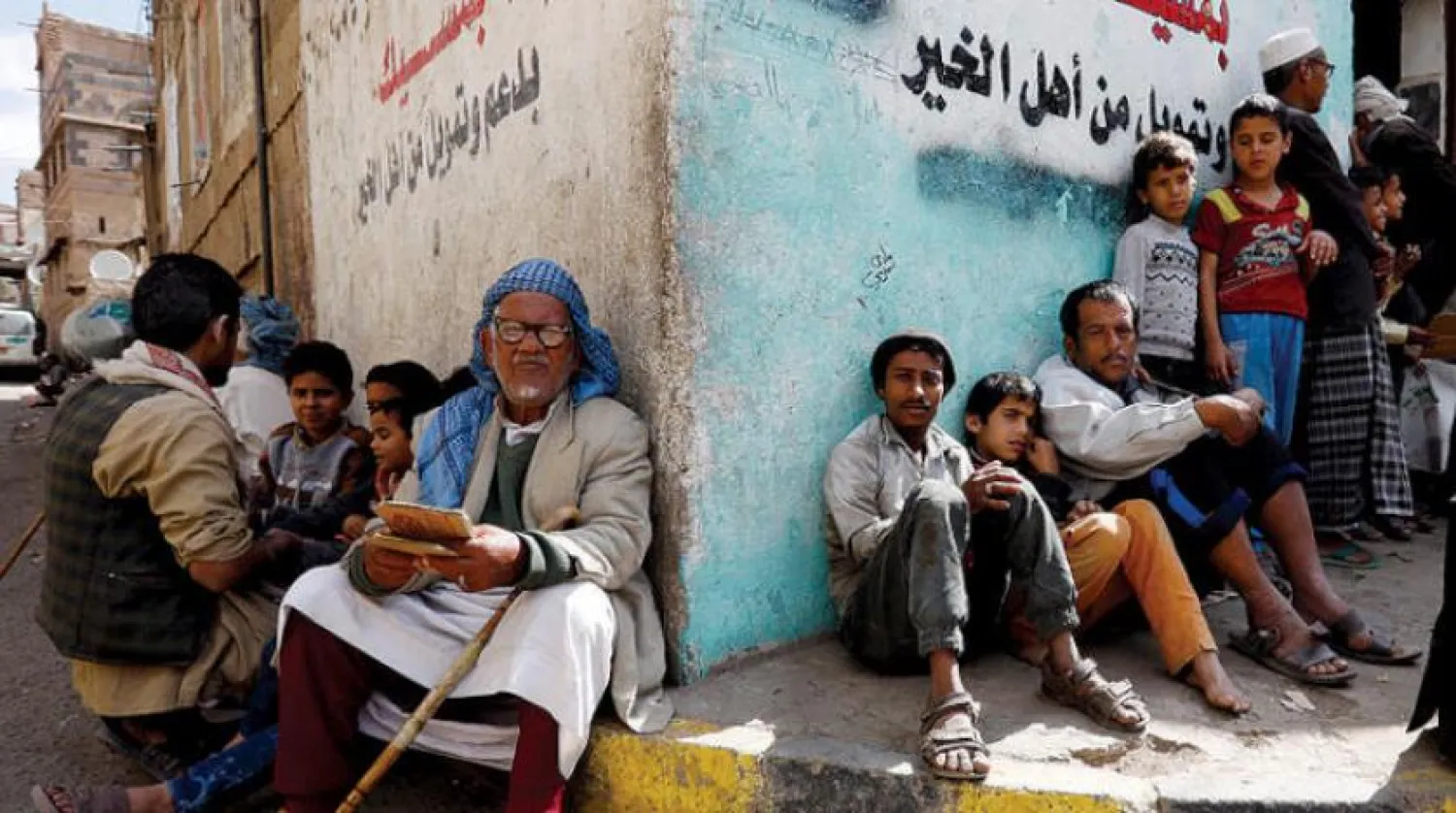 Conflict-ridden people wait to get their families' free food rations from a charity kitchen in Sanaa, Yemen, 12 December 2019. EPA/YAHYA ARHAB