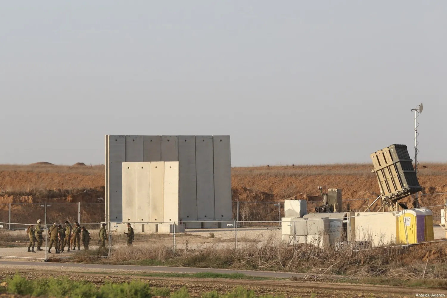 Soldiers stand near a battery of Iron Dome defense missile system, designed to intercept and destroy incoming short-range rockets and artillery shells in the southern Israeli city of Sderot on 13 November 2019. [Mostafa Alkharouf - Anadolu Agency]