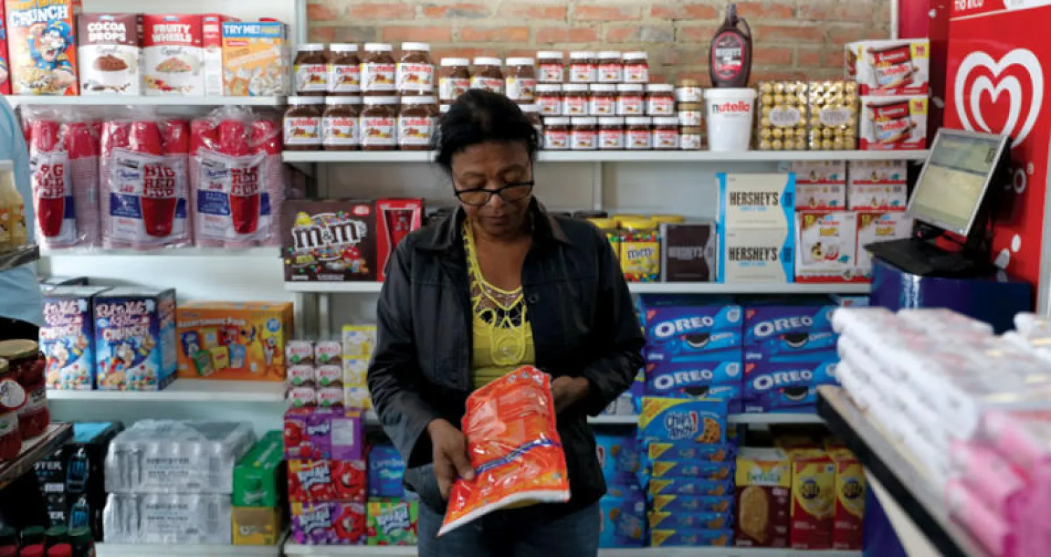 سيدة تتسوق في العاصمة الفنزويلية كراكاس (رويترز)