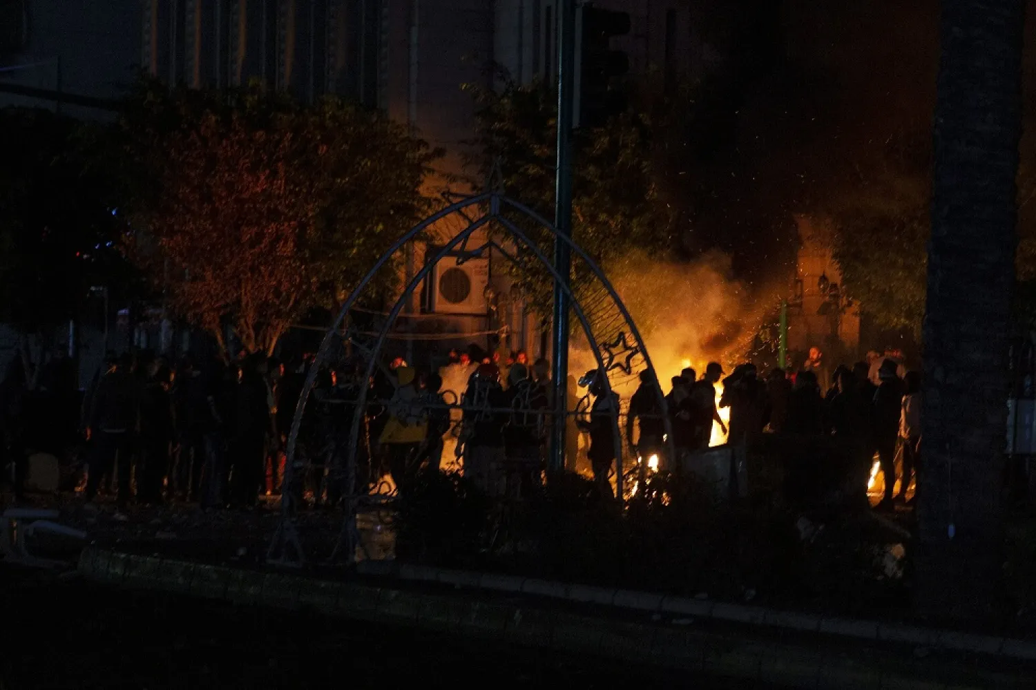 Supporters of Lebanon's former Prime Minister Saad Hariri burn tires as they clash with security forces and close a road in Beirut, Lebanon, Friday, Dec. 20, 2019. (AP)