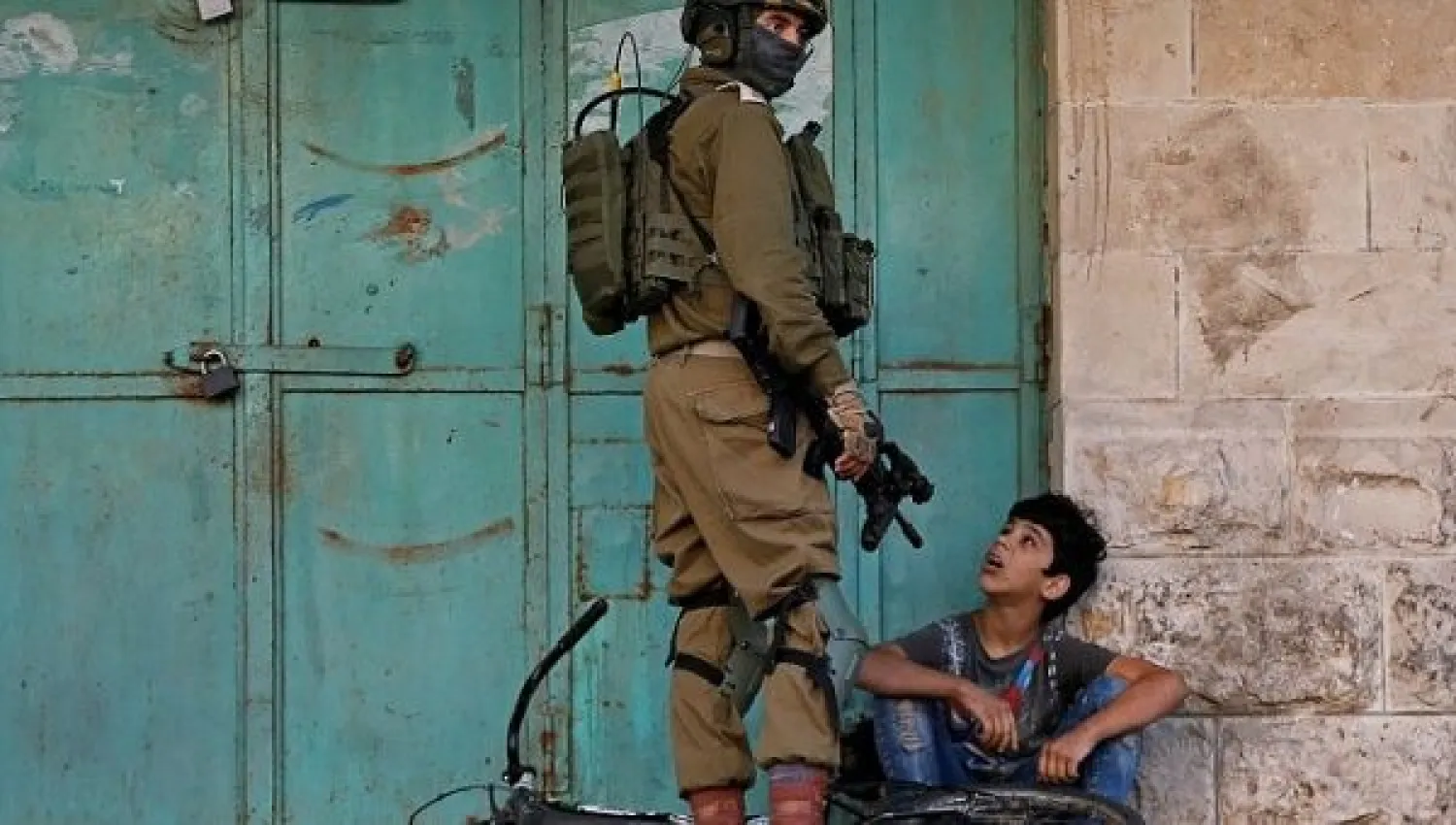 Israeli soldier detains a Palestinian boy in the Israeli-occupied West Bank, Nov. 29, 2019. (Reuters)