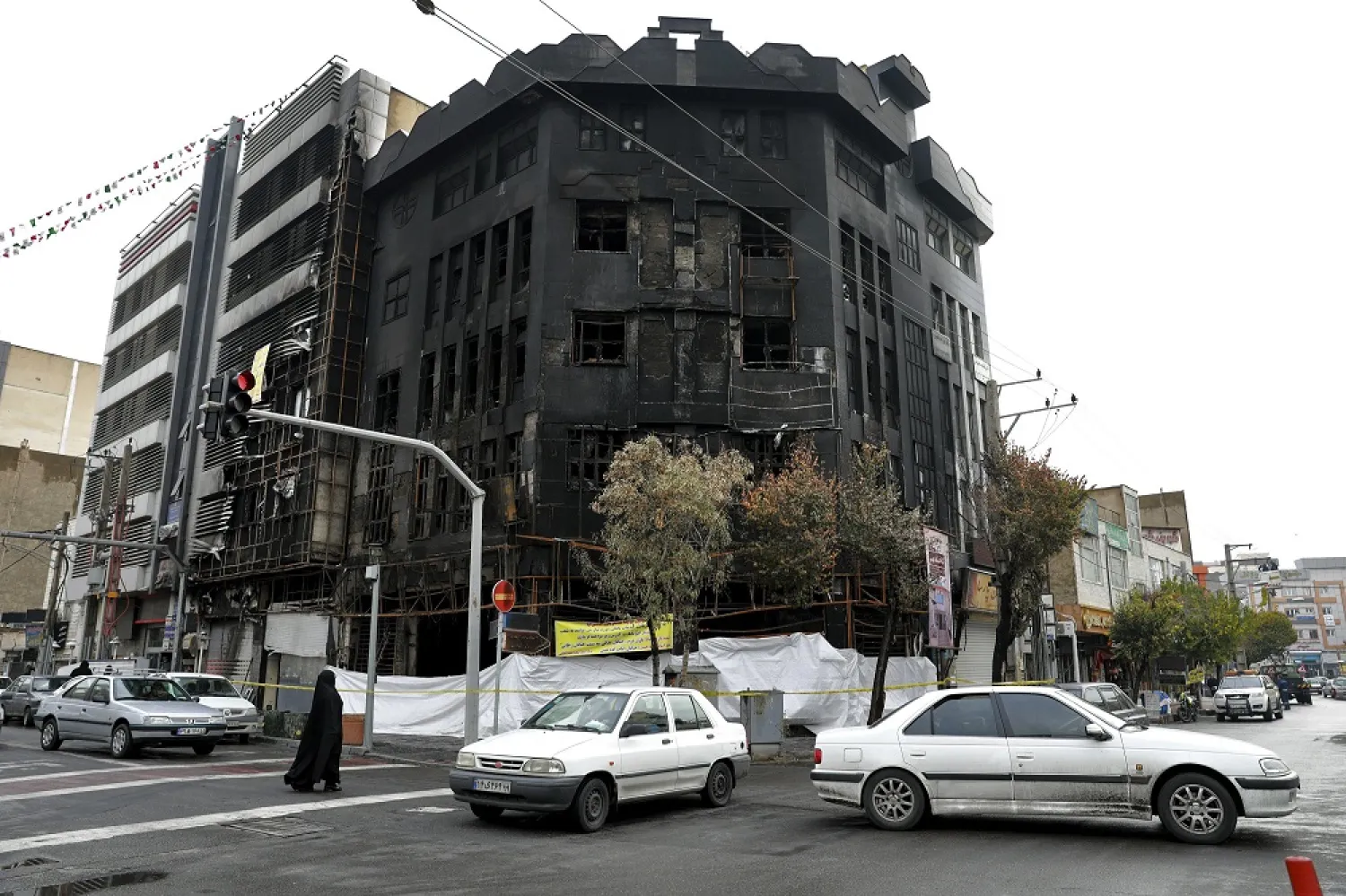 In this Nov. 20, 2019 file photo, traffic passes a building that was set ablaze during recent protests over government-set gasoline prices rises, in Tehran, Iran. (AP)