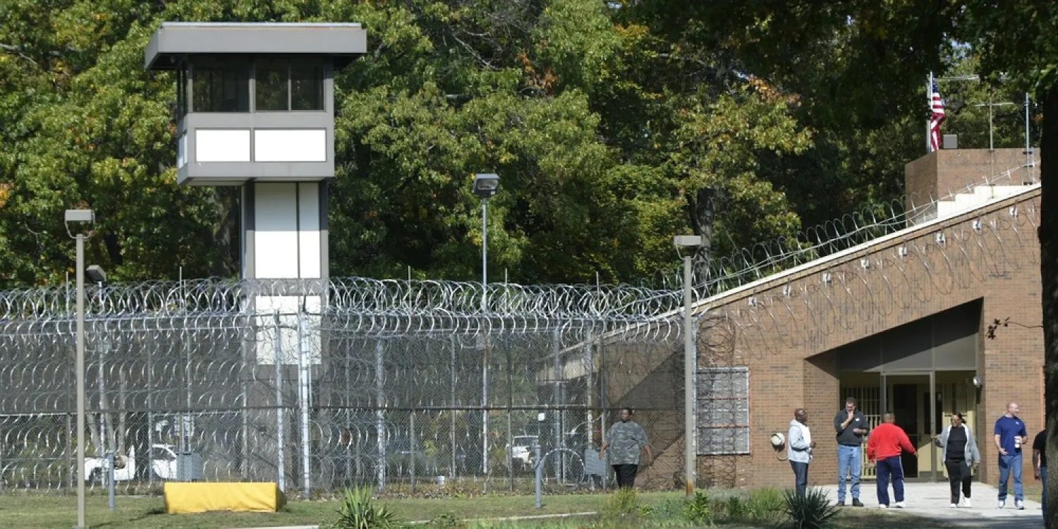 Employees walk in the yard of Muskegon Correctional Facility in Muskegon, Mich., on Oct. 4, 2012. (AP)