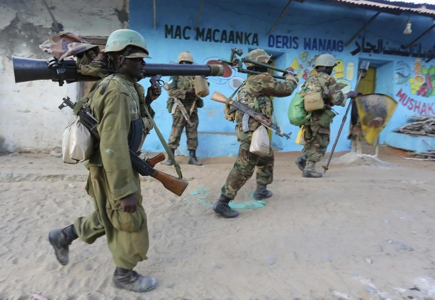 Somalia's army soldiers and peacekeepers from the African Union Mission in Somalia enter the town of Barawe during the second phase of Operation Indian Ocean October 6, 2014. (Reuters)