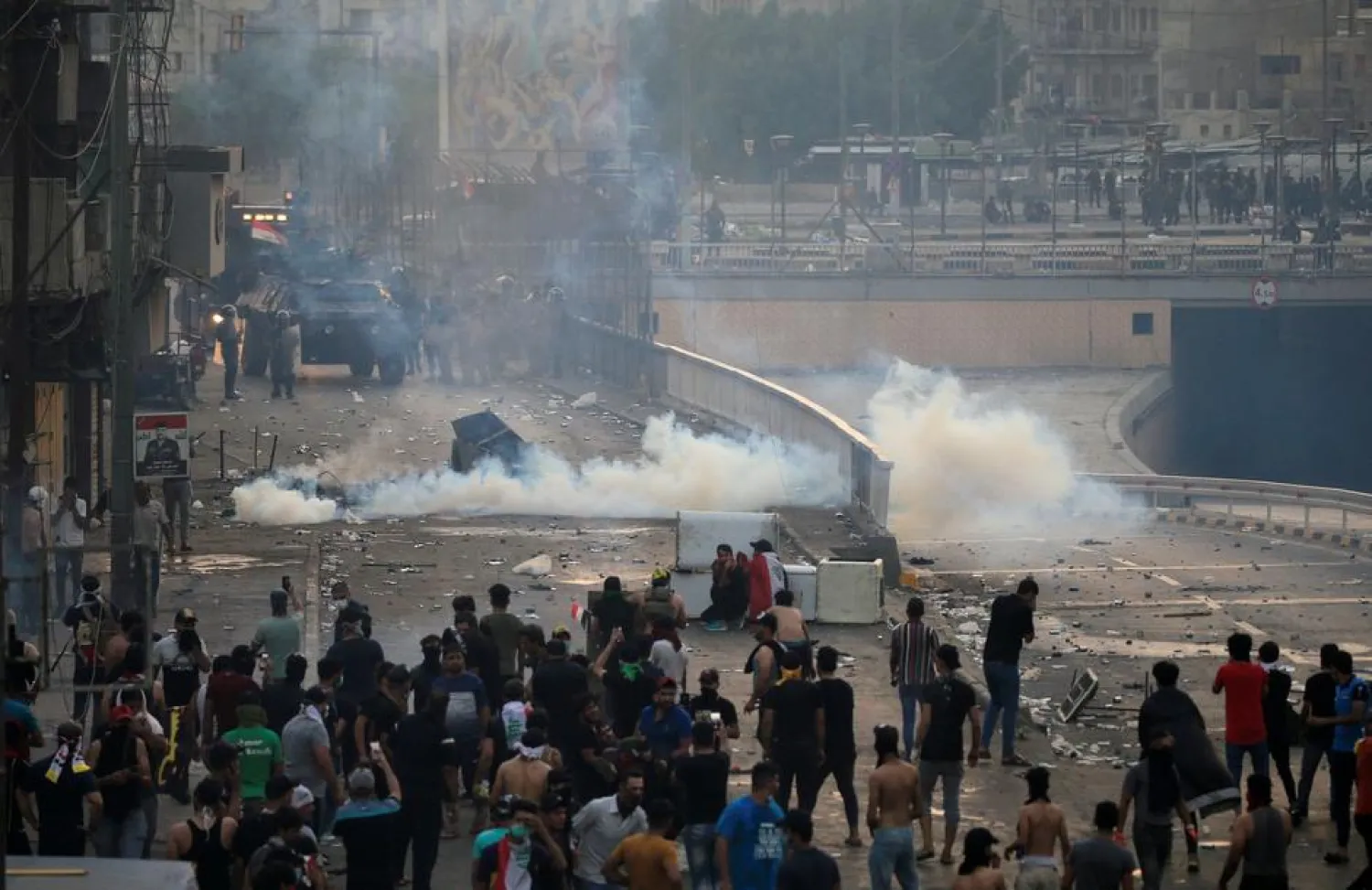 Demonstrators disperse as Iraqi security forces use tear gas during a protest over unemployment, corruption and poor public services, in Baghdad, Iraq October 2, 2019. REUTERS/Thaier al-Sudani
