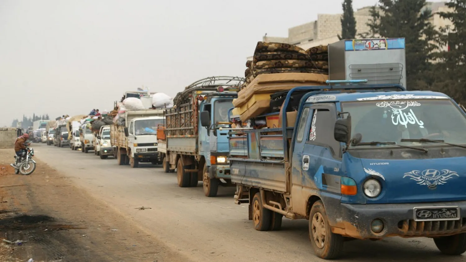Trucks carry belongings of people fleeing from Maaret al-Numan in Idlib, Syria on December 24, 2019. (Reuters)