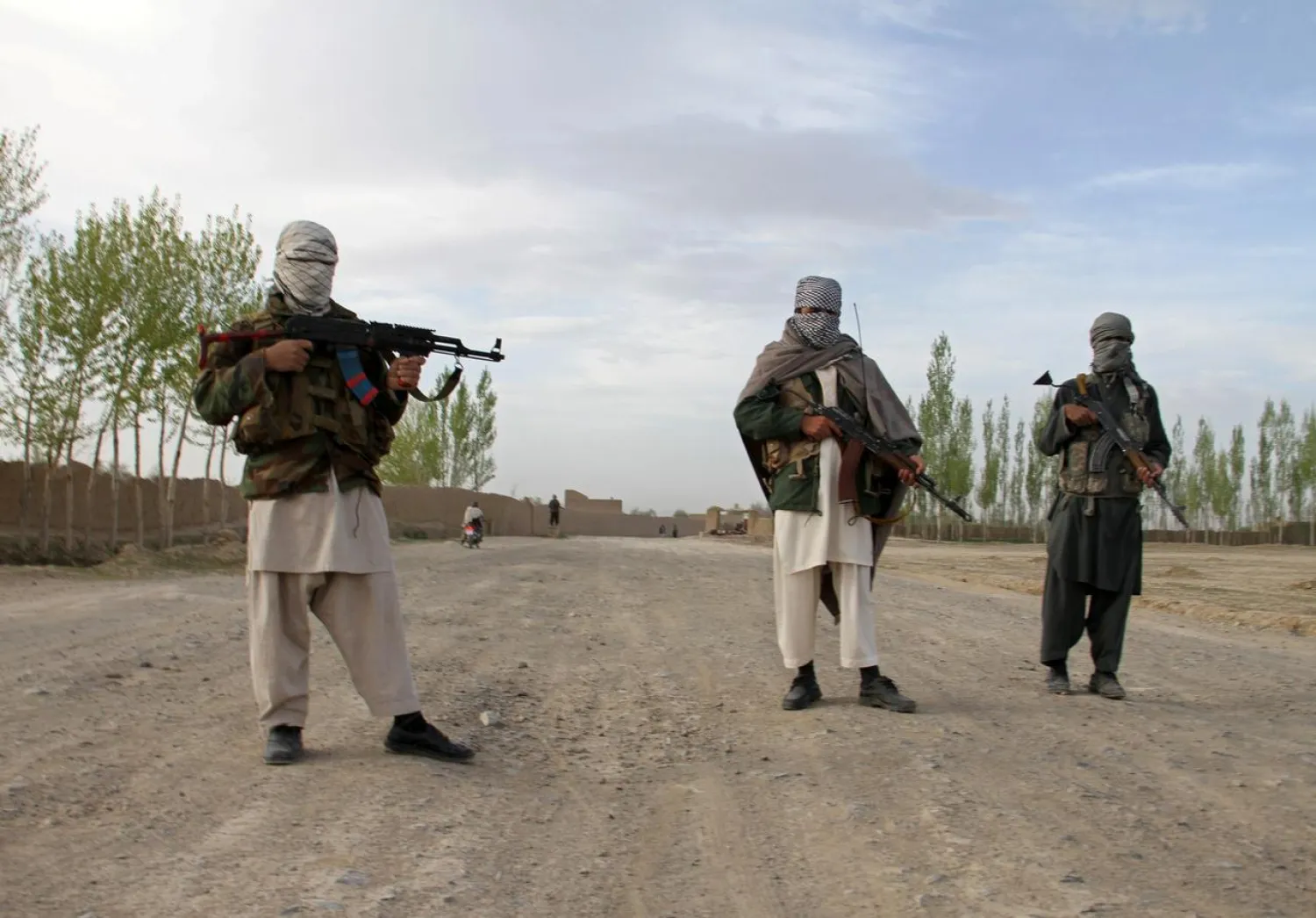 Members of the Taliban stand at the site of the execution of three men in Ghazni province, Afghanistan, April 18, 2015. REUTERS/Stringer/File Photo
