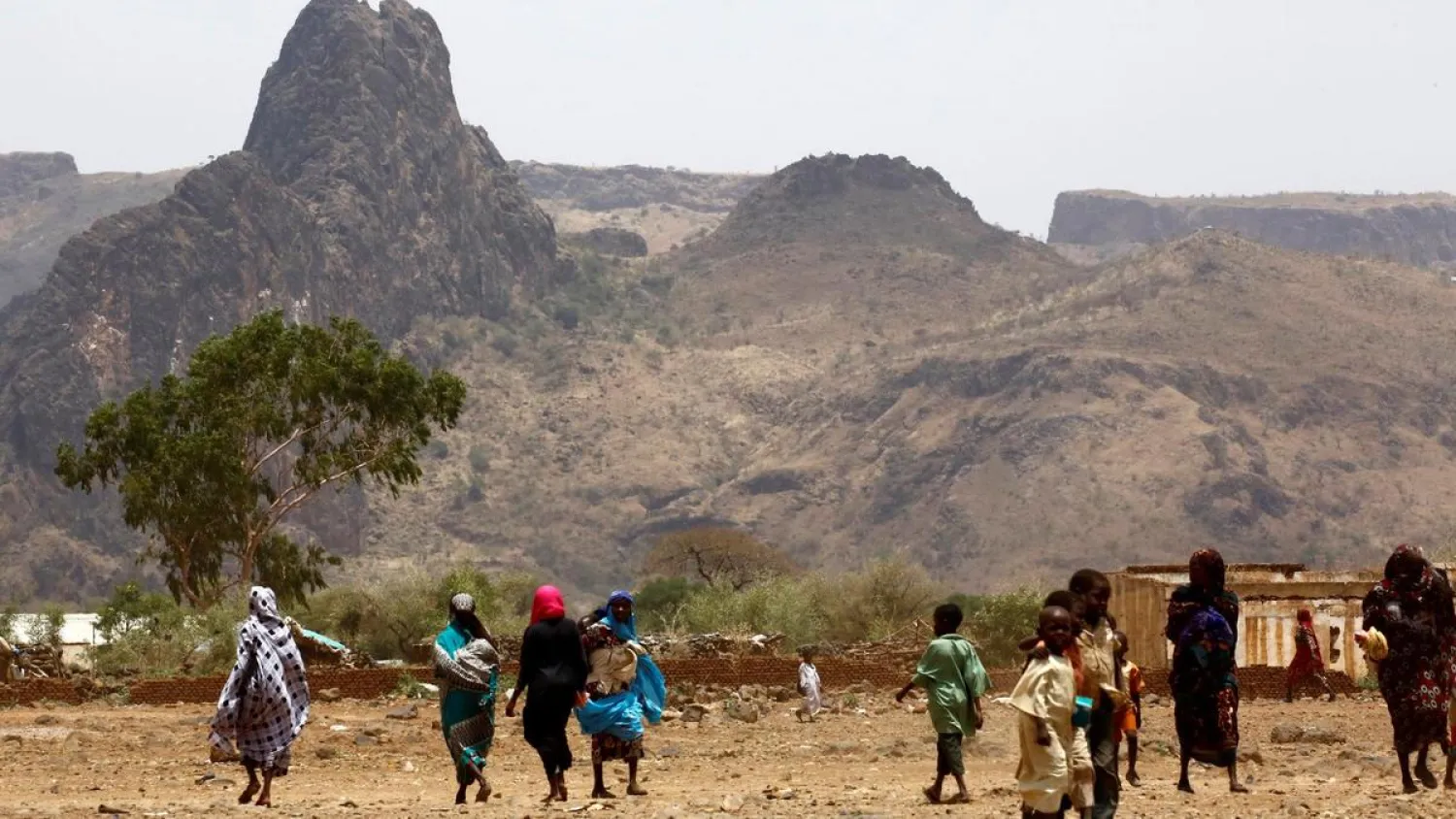 Sudanese villagers walk in the war-torn town of Golo in the thickly forested mountainous area of Jebel Marra in central Darfur on June 19, 2017. (AFP)