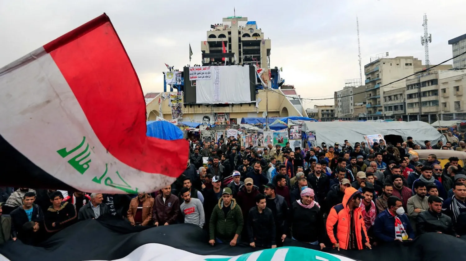 Iraqi demonstrators carry Iraqi flags during ongoing anti-government protests in Baghdad, Iraq, December 27, 2019. (Reuters)