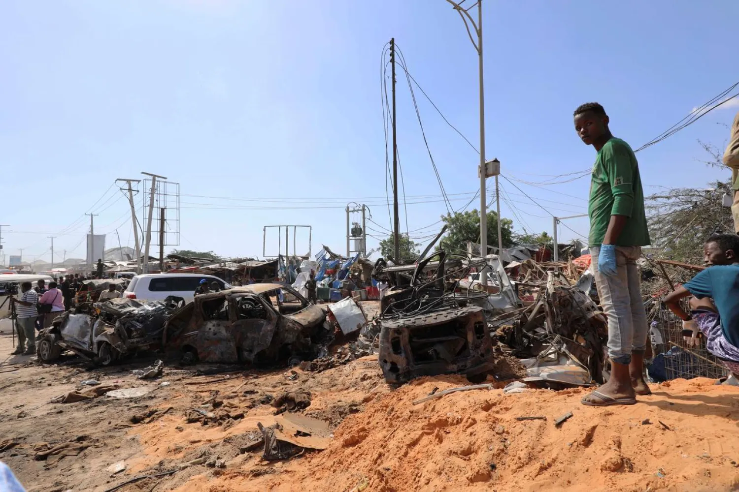 A Somali man stands at the scene of a car bomb explosion at a checkpoint in Mogadishu, Somalia December 28, 2019. (Reuters)