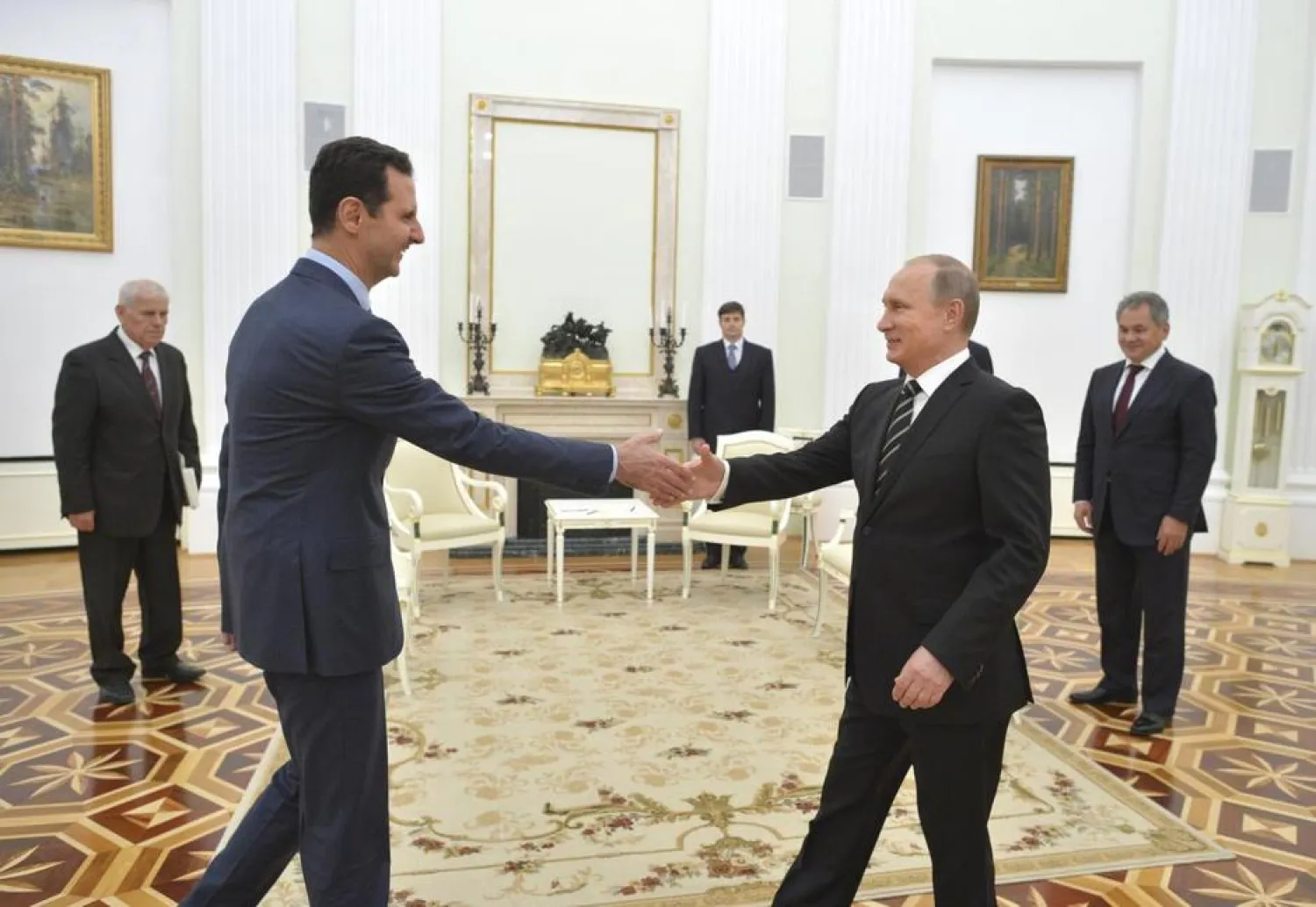 Russian President Vladimir Putin (R) shakes hands with Syrian President Bashar al-Assad during a meeting at the Kremlin in Moscow, Russia, October 20, 2015. REUTERS/Alexei Druzhinin/RIA Novosti/Kremlin
