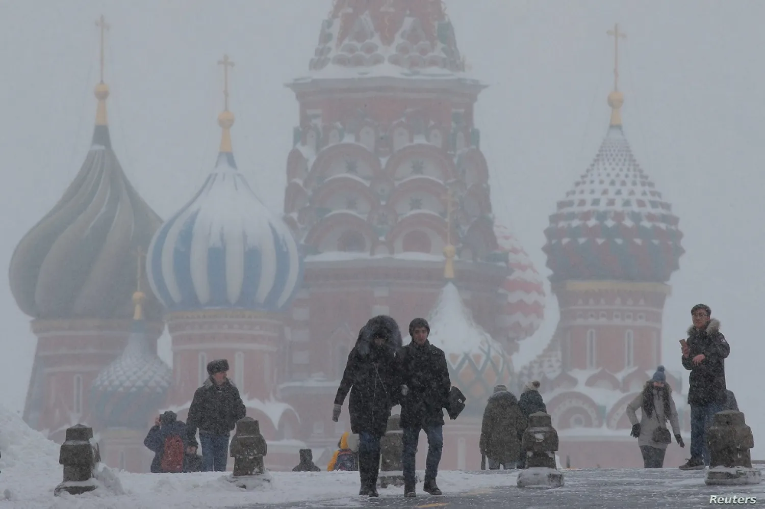 People walk in Red Square during heavy snowfall in Moscow, Russia, Jan 27, 2019. (Reuters)