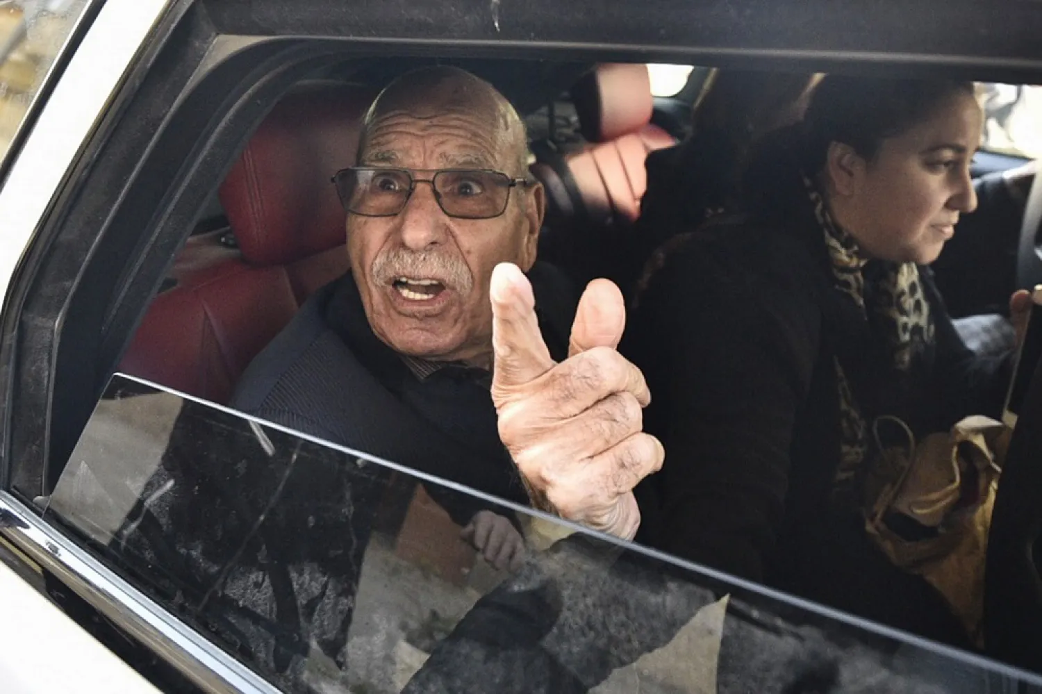 Algerian war veteran Lakhdar Bouregaa gestures in a car upon his release in Algiers on Jan. 2, 2020. (AFP)