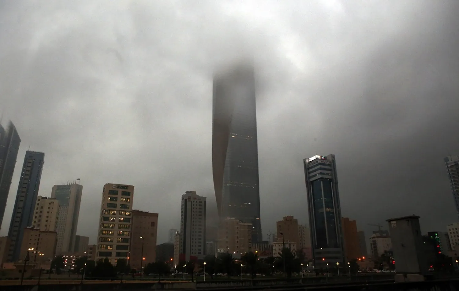 Clouds cover buildings in Kuwait City during a heavy rainfall on November 18, 2013. (AFP)