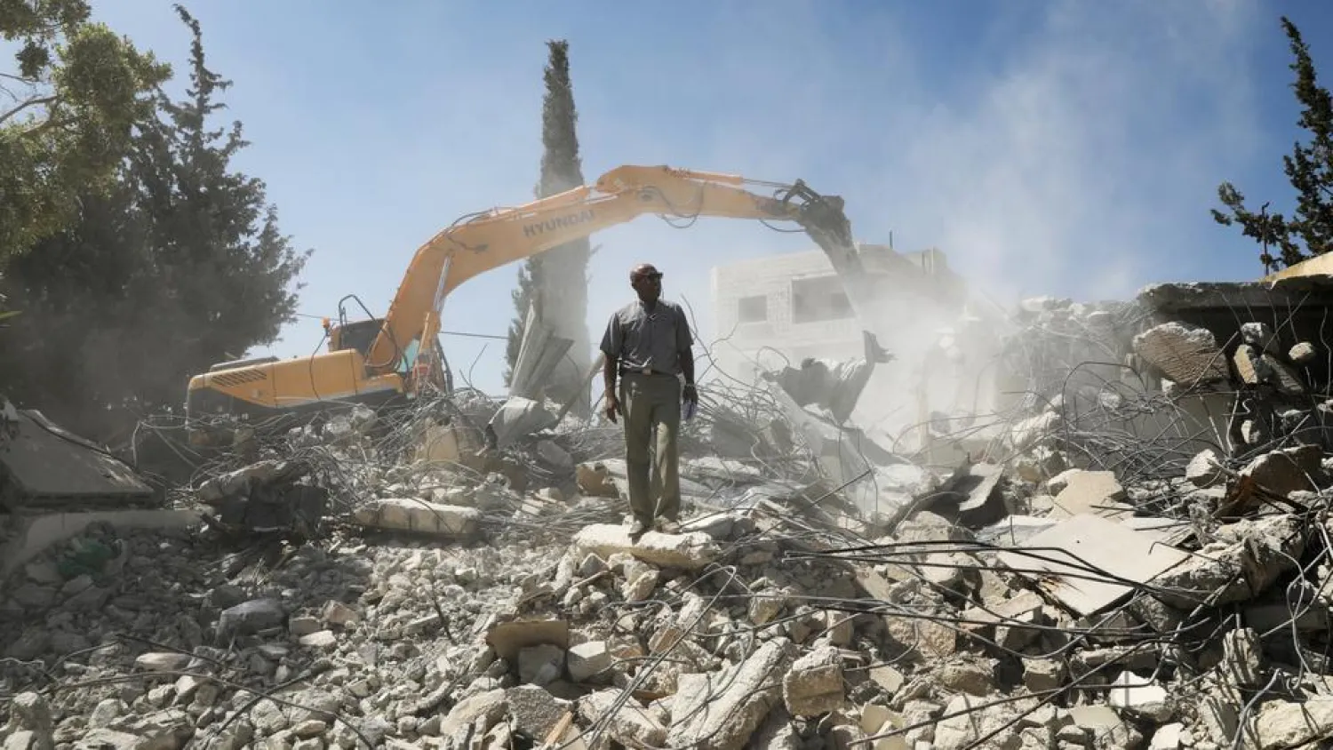 Palestinian Jihad Shawamrah stands on the ruins of his house that he demolished to not face the prospect of Israeli settlers moving in after he lost a land ownership case in Israeli courts, in the East Jerusalem neighborhood of Beit Hanina. (Reuters)