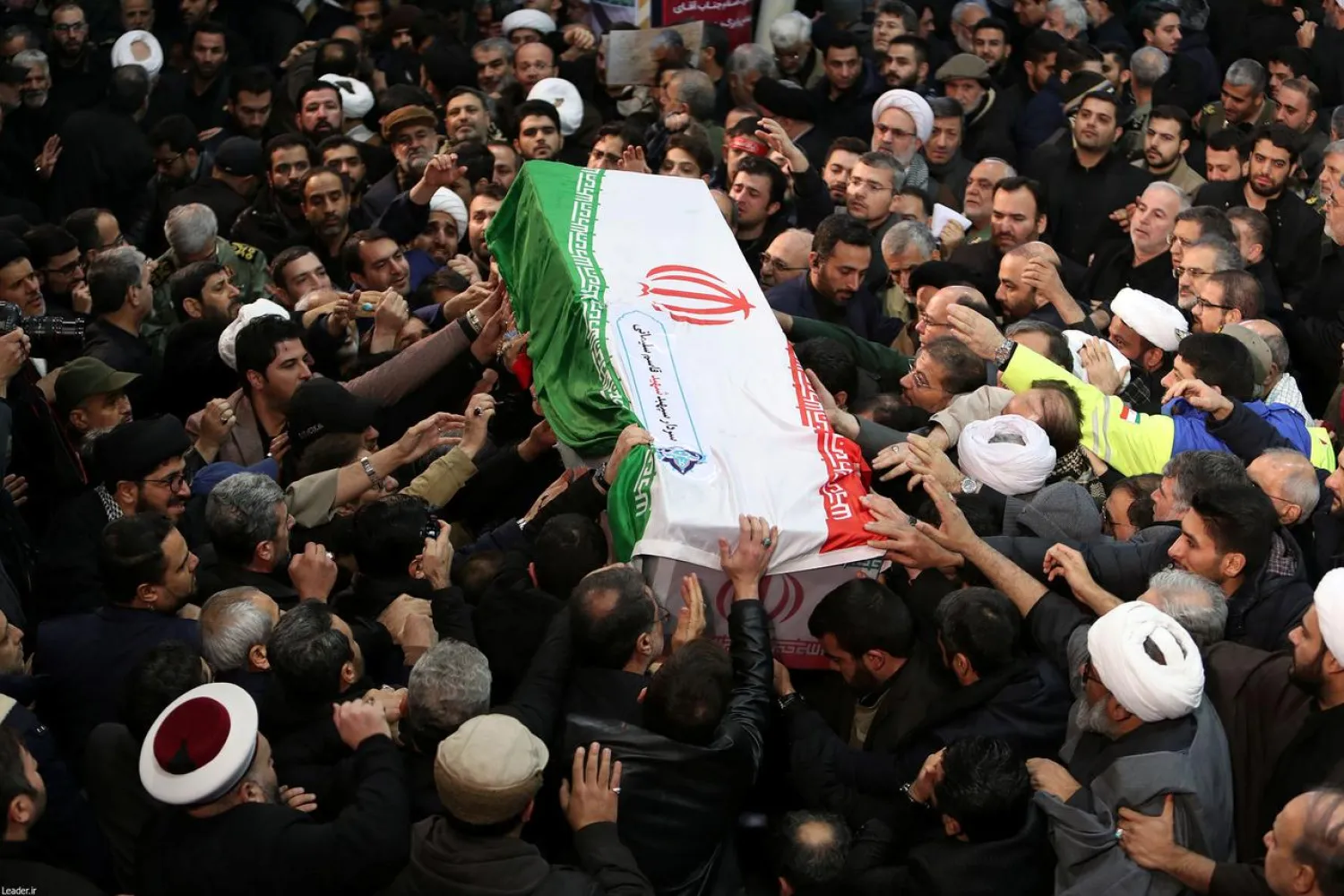 FILE PHOTO: Iranian people carry a coffin of Qassem Soleimani during a funeral procession in Tehran, Iran January 6, 2020. Official Khamenei website/Handout via REUTERS