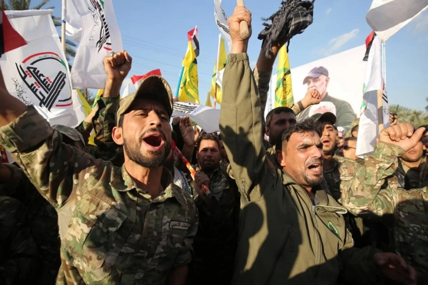 Popular Mobilization Forces members chant anti-US slogans during a protest on Monday over the killings of Qassem Soleimani and Iraqi PMF commander Abu Mahdi Al-Muhandis. (AFP)