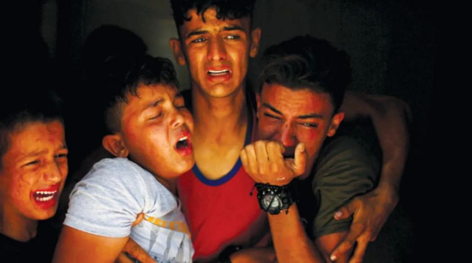 A Palestinian family mourns death of one of its members during demonstrations near the Gaza-Israel border (Reuters)