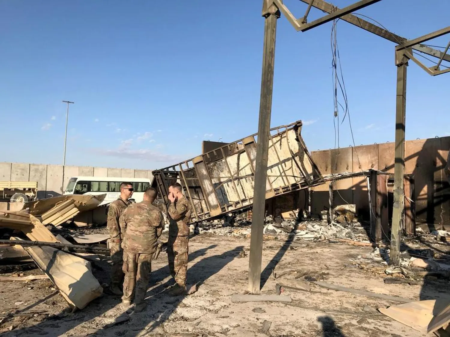 US soldiers are seen at the site where an Iranian missile hit at Ain al-Asad air base in Anbar province, Iraq (Reuters)