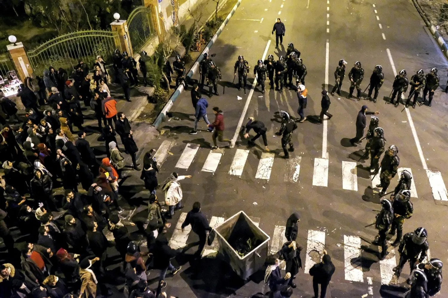 In this photograph taken on Jan. 11, Iranian police officers take position while protesters gather in front of Amir Kabir University in Tehran, to remember victims of the Ukraine plane crash. (AP)