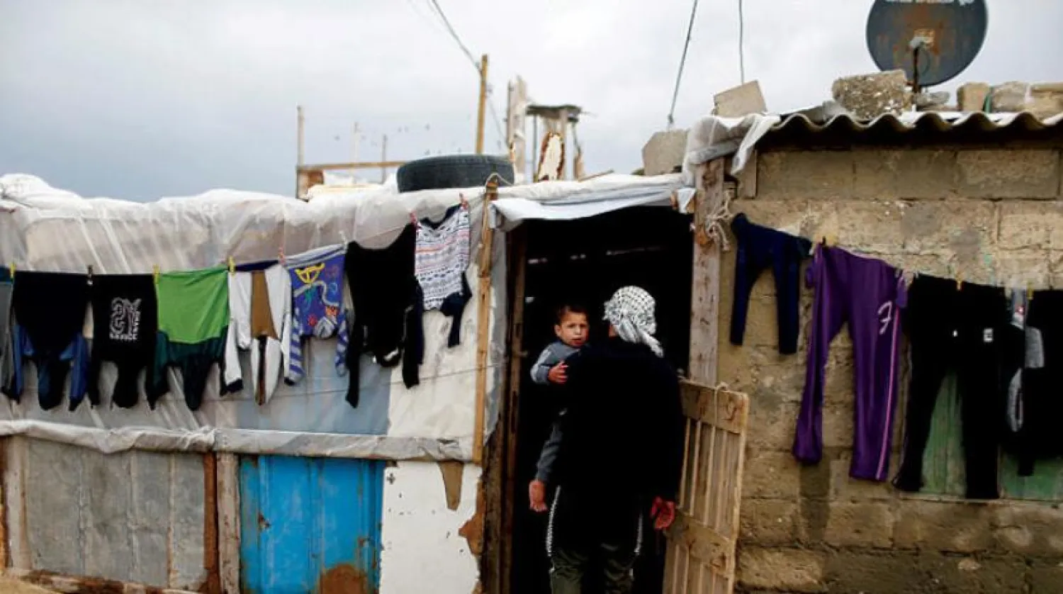 A Palestinian enters his home in southern Gaza Strip on a rainy day (Reuters)