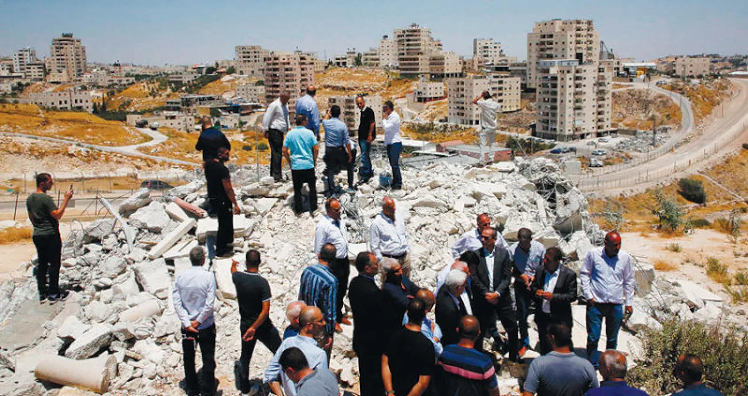 هدم 12 منزلاً فلسطينياً عدّتها إسرائيل غير قانونية ببلدة سور بحر قرب القدس في يوليو الماضي (أ.ف.ب)