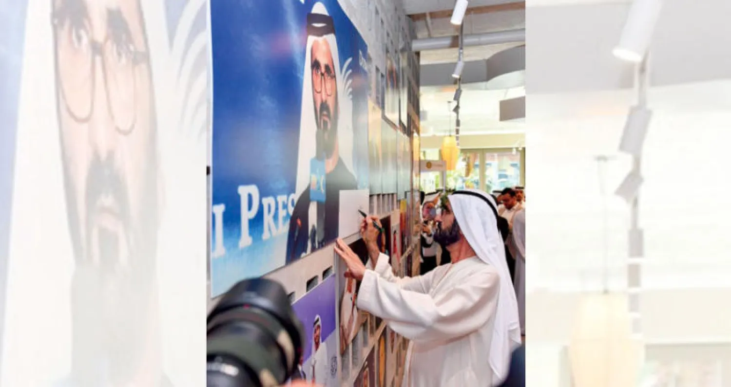 الشيخ محمد بن راشد آل مكتوم يوقّع على صورة تاريخية خلال حضوره احتفالية «نادي دبي للصحافة» (المكتب الإعلامي لحكومة دبي)