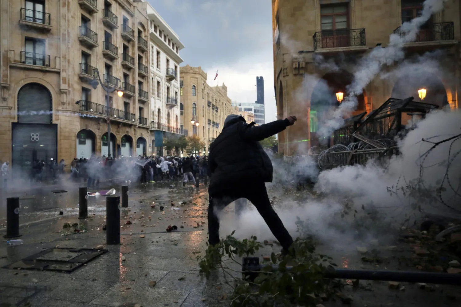 Anti-government protesters clash with the riot police, during a protest at a road leading to the parliament building in Beirut, Lebanon, Saturday, Jan. 18, 2020. (AP)