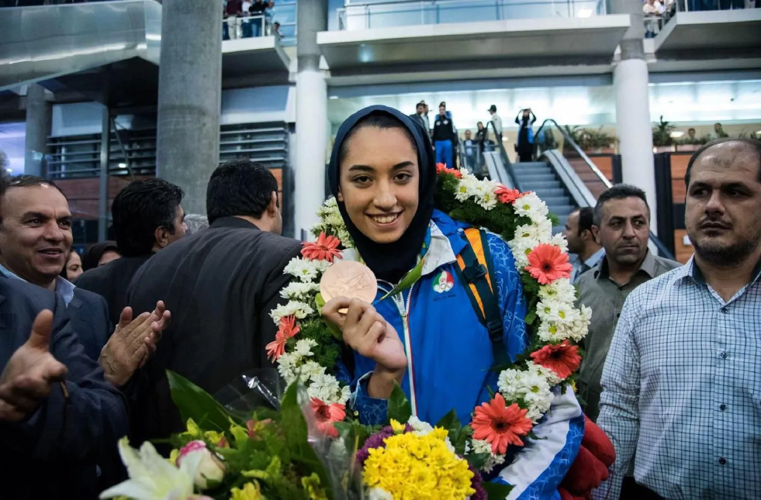Kimia Alizadeh, who became the first Iranian woman ever to win an Olympic medal, pictured in 2016 with her medal at Tehran's Imam Khomeini International Airport | AFP