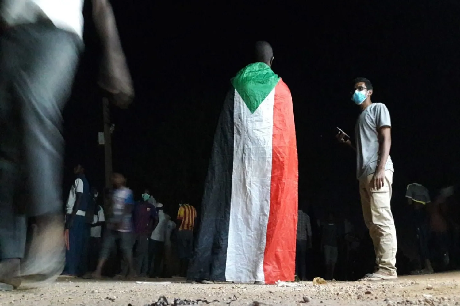 A Sudanese demonstrator wears the national flag during an anti-government protest in Khartoum, Sudan on January 22, 2019. (Getty Images)