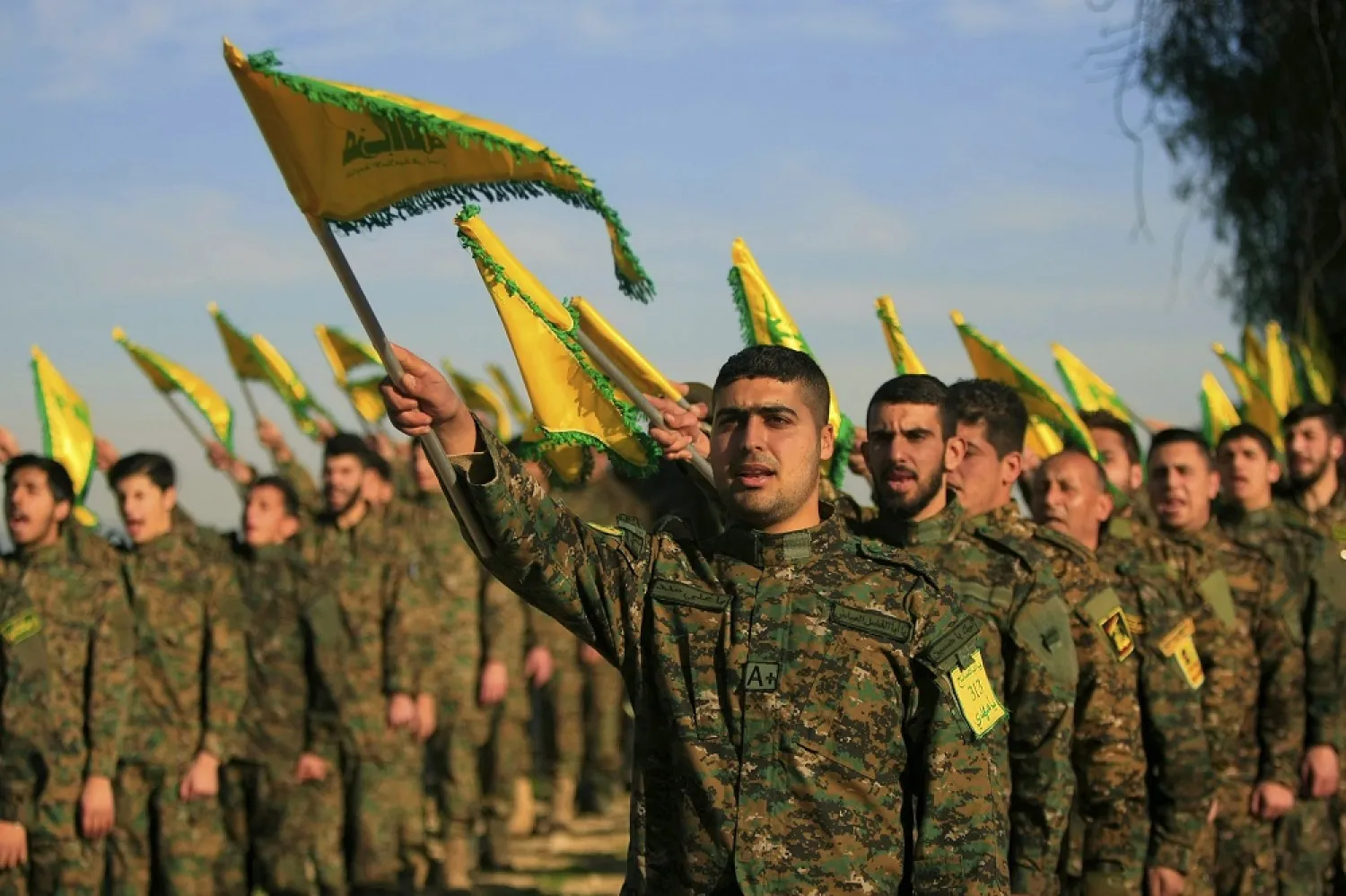 Hezbollah fighters hold flags, as they attend the memorial of slain leader Sheikh Abbas al-Mousawi, killed by an Israeli airstrike in 1992, in Tefahta village, south Lebanon, February 13, 2016. (AP)