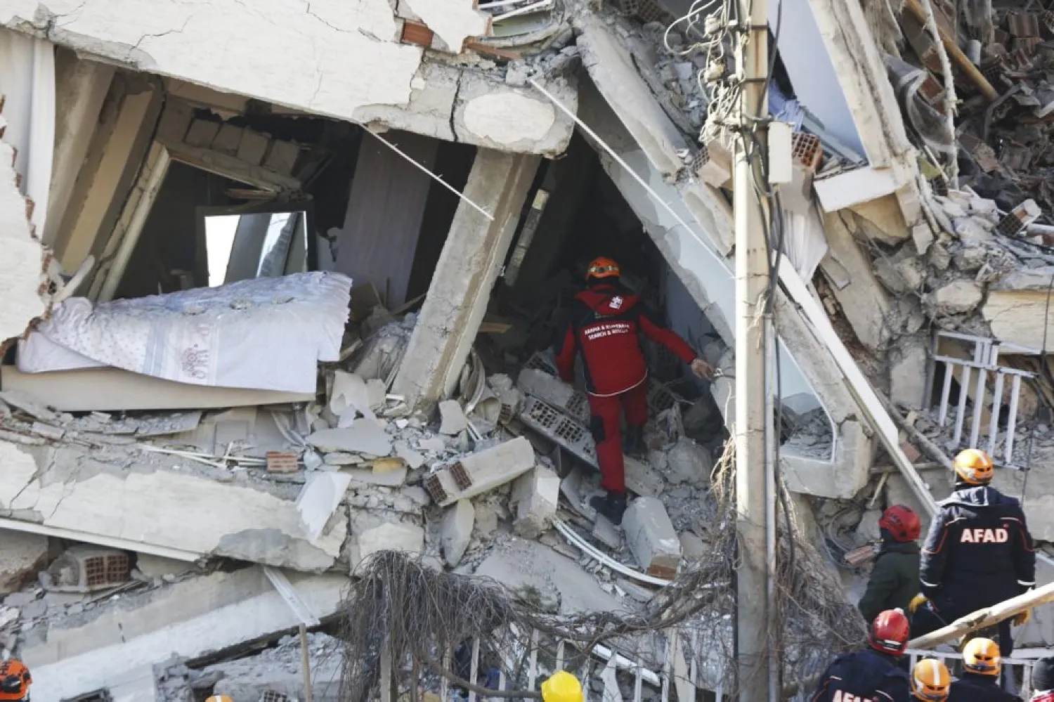 Rescuers work on searching for people buried under the rubble on a collapsed building, after an earthquake struck Elazig, eastern Turkey, Saturday, Jan. 25, 2020. (AP)