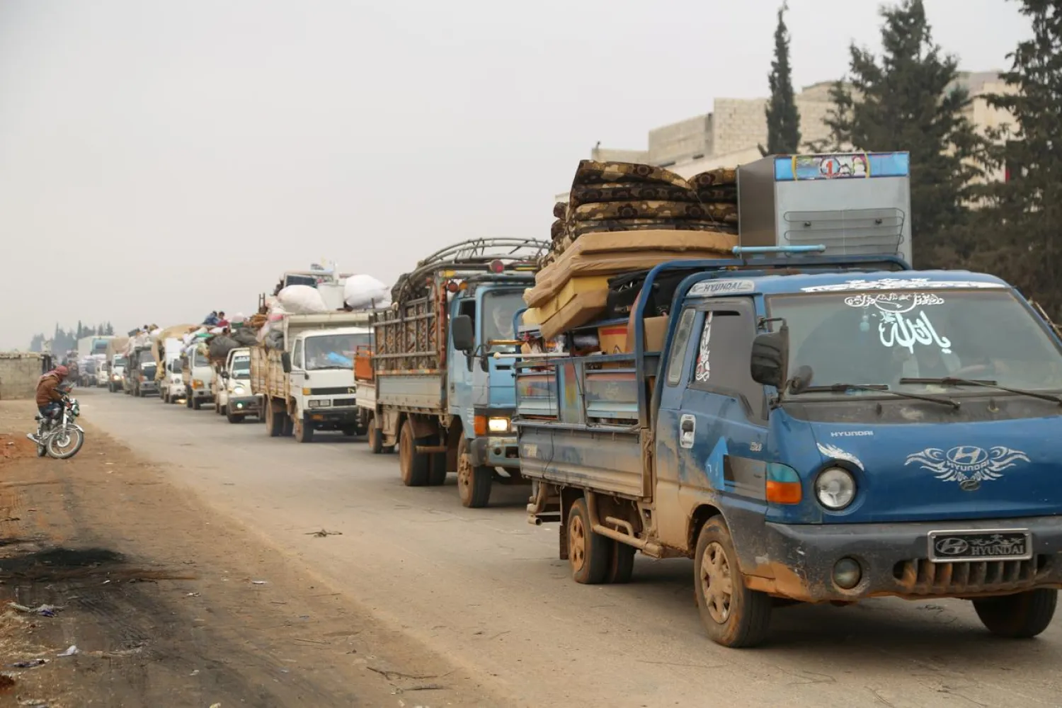 Trucks carry belongings of people fleeing from Maarat al-Numan, in northern Idlib, Syria December 24, 2019. (Reuters)