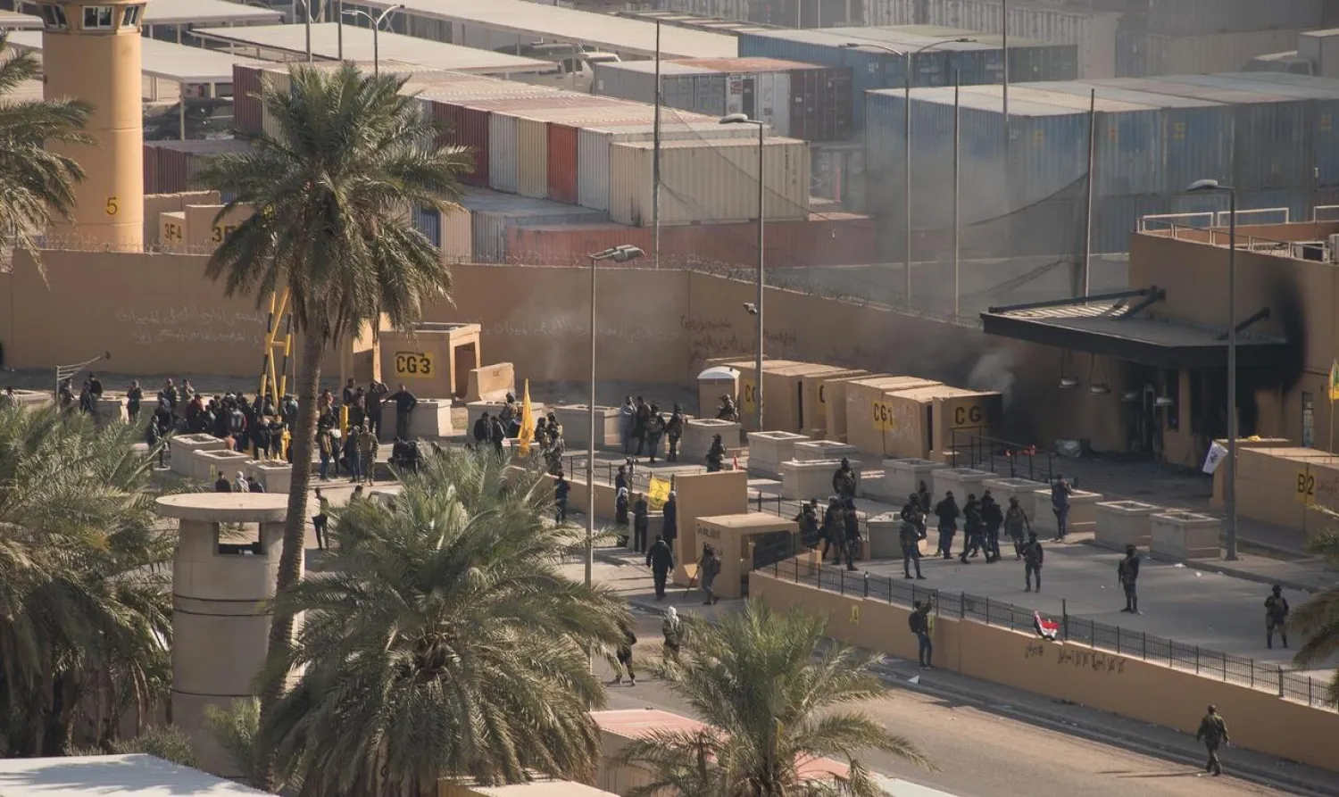 Iraqi security forces and protesters stand outside the US embassy in Baghdad, Iraq January 1, 2020. DoD/Lt. Col. Adrian Weale/Handout via REUTERS.